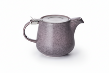 Two ceramic teapots, one purple and one blue, on a white background