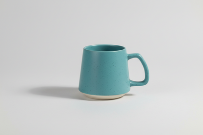 Blue mug with speckled pattern on a white background