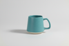 Blue mug with speckled pattern on a white background