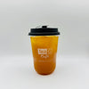 A clear plastic takeaway cup filled with amber-orange iced tea, topped with a black lid, and printed with the Tea G Cafe logo on a light gray background.