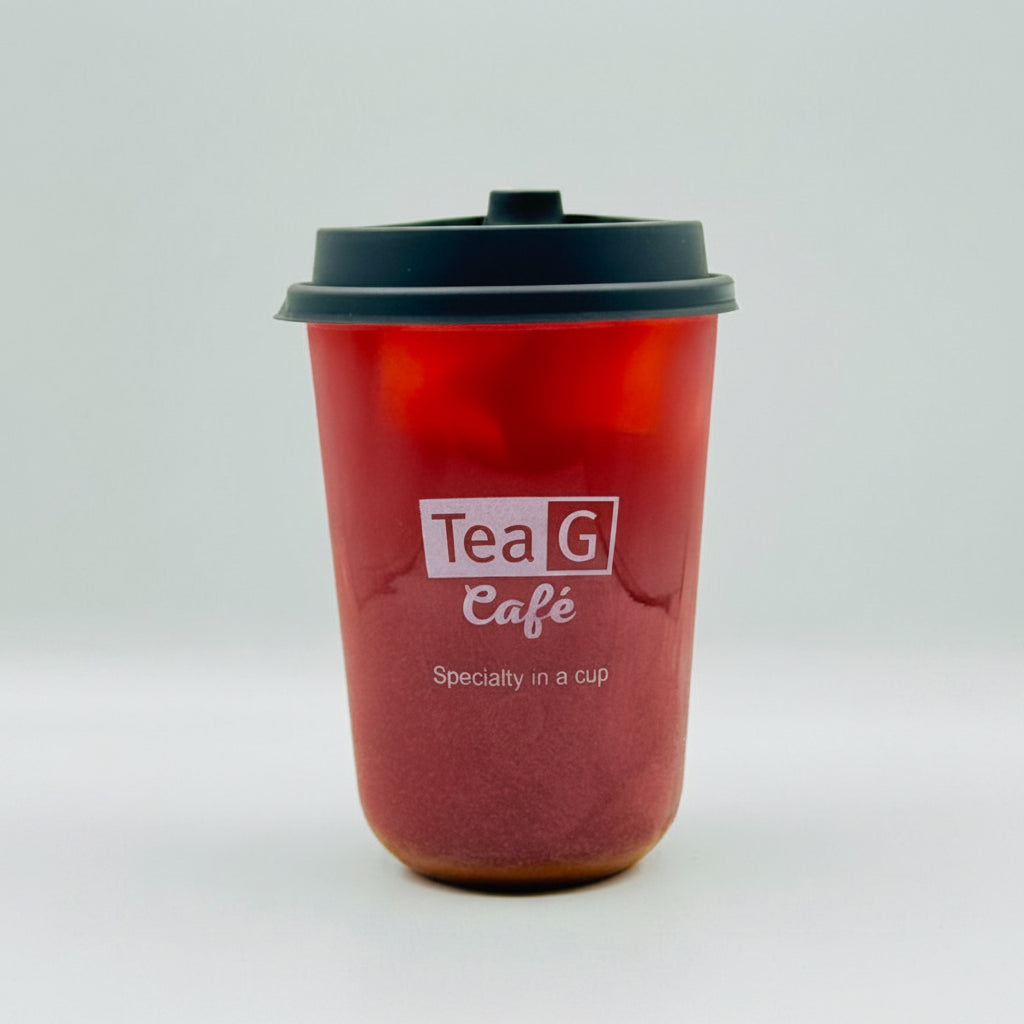 A translucent red reusable coffee cup with a black lid and a printed white logo reading 'Tea G Café' on the front, photographed against a light gray studio background.