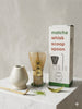 Matcha whisk, scoop, and spoon set with packaging on a light surface.